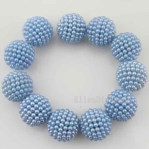 May include: A strand of light blue pearl beads, each bead is a sphere covered in smaller pearls. The beads are arranged in a circle.
