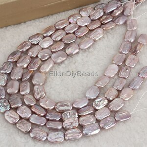 May include: A strand of pale lavender baroque freshwater pearl beads. The pearls are oval shaped and have a slightly irregular surface. The beads are strung on a white thread and are ready to be used for jewelry making.