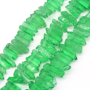 May include: A strand of green crystal point beads. The beads are faceted and have a natural, raw look. They are strung on a wire and are ready to be used in jewelry making.