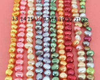 May include: Ten strands of freshwater pearls in various colors, including gold, pink, white, gray, green, and red. The pearls are arranged in rows, numbered 13 through 22.