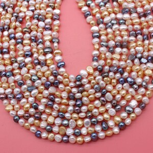 May include: A strand of freshwater pearls in a variety of colors, including white, cream, and purple. The pearls are irregular in shape and have a smooth, lustrous finish.