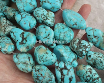 May include: A strand of turquoise gemstone beads, each bead is a unique, irregular shape with a mottled blue and green color. The beads are strung on a clear thread.