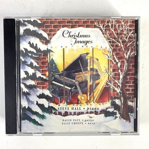 May include: A Christmas music CD featuring a snowy winter scene with a grand piano, harp, and guitar. The title of the album is "Christmas Images" and the musicians are Steve Hall on piano, David Payt on guitar, and Ellie Choate on harp.