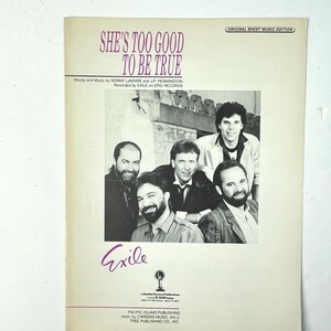 May include: A sheet music cover for the song "She's Too Good To Be True" by Exile. The cover features a black and white photo of the band members. The title of the song is printed in large, bold letters.