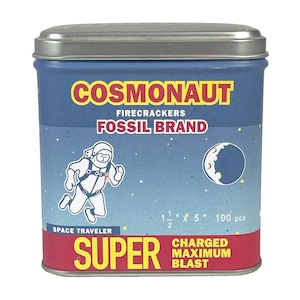 May include: A blue tin with a silver lid featuring the text "COSMONAUT FIRECRACKERS FOSSIL BRAND". The tin has an illustration of an astronaut and a crescent moon. The text "SUPER CHARGED MAXIMUM BLAST" is also visible. The tin measures 1 1/2" x 5".