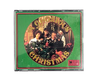 May include: A CD case with a green background and a red border. The CD cover features a family gathered around a Christmas tree, with the words "My Glorious Christmas" in a circular design.