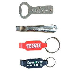May include: A collection of bottle openers and keychains. The top opener is silver with text that reads "CERVEZA PACIFICO NADA MAS". Below is a silver bottle opener. Two keychains are red and black with the text "TECATE" and "Papas & Beer BAJA-MEXICO".