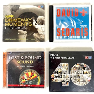 May include: Four CD cases are displayed. The top left case is titled "NPR Driveway Moments for Dads." The top right case is "David Sedaris Live at Carnegie Hall." The bottom left case is "Lost & Found Sound." The bottom right case is "NPR The First Forty Years."