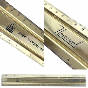 May include: A vintage gold-toned ruler with black markings and the text "Flavorseal" and "FMC INTERNATIONAL." The ruler measures up to 12 inches and features both inch and millimeter increments. The ruler has a metallic finish.
