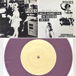 May include: A vinyl record with a purple label and a yellow centre is displayed. Above it are three black and white images with the band name "PIXIES" and text including "PEEL SESSIONS 6.7.88" and "WILD HONEY PIE".