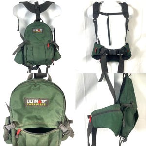 May include: A green Ultimate Torsopacs backpack with black straps and red zipper accents. The backpack has multiple compartments and adjustable straps. The text "ULTIMATE TORSOPACS" is printed on the front of the backpack.