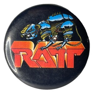 Könnte beinhalten: Ein schwarzer und roter Knopf mit einer Roboter-Ratte und dem Wort "RATT" in roten Buchstaben.