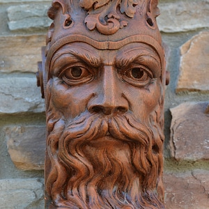 May include: A wooden wall corbel bracket featuring a bearded man's face with intricate details. The bracket is 12 inches long and is made of two-tone redwood.