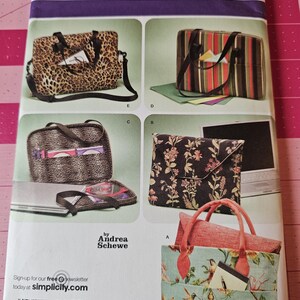 May include: Simplicity sewing pattern featuring various bag designs. The bags include a leopard print tote, a striped laptop bag, a floral clutch, and a tote with a floral and bird print. The pattern is by Andrea Schewe.