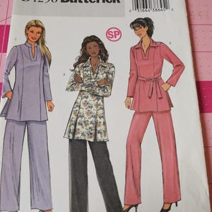 May include: A vintage Butterick sewing pattern, B4296, with illustrations of three women's outfits. The outfits include a lavender tunic and trousers, a floral print jacket and grey trousers, and a pink tunic and trousers set.