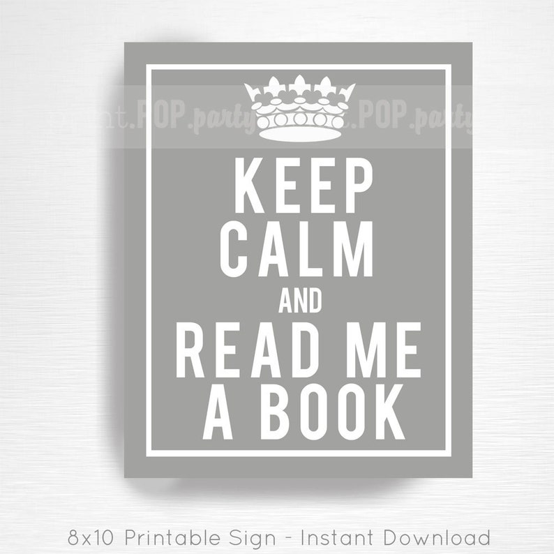 May include: A gray rectangular sign with a white border and text that reads "KEEP CALM AND READ ME A BOOK." A white crown is at the top. The sign is 8x10 inches.