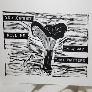 May include: Black and white linocut print of a mushroom with the text "You cannot kill me in a way that matters".