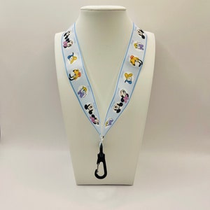 Mickey & Friends faces (Minnie, Daisy, Donald, Pluto) on light blue Ribbon Lanyard