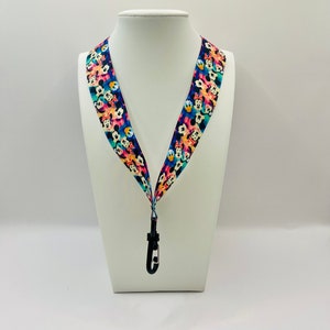 Mickey & Friends faces (Minnie, Goofy, Donald) on light rainbow Ribbon Lanyard