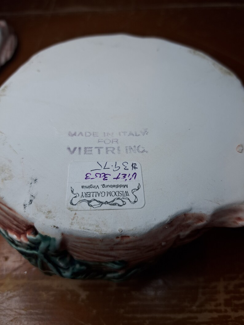 May include: A white ceramic bowl with a floral design. The bowl is made in Italy for Vietri Ing. The bowl is priced at &pound;32.00 and is available at Wisdom Gallery in Middleburg, Virginia.