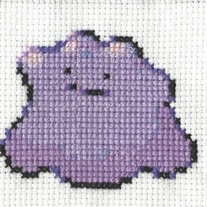 May include: Purple and black cross-stitch of a Pokemon character, a blob-like creature with a round body and no limbs.
