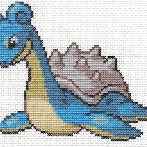 Puede incluir: Patrón de punto de cruz de un personaje Pokemon azul y marrón, Blastoise, con un caparazón en la espalda.