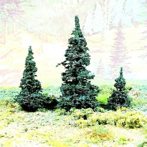 May include: Three green pine trees against a blurred background of a light blue and yellow sky. The trees are different sizes and shapes, with the tallest tree in the center.