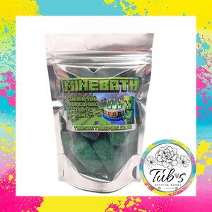 May include: A silver-coloured bag containing green bath bombs. The label says "MINEBATH" with a Minecraft-themed design and the text "THANK YOU FOR COMING TO MY PARTY". A circular sticker with a floral design and the text "Tub's Bath Bombs" is on the right.