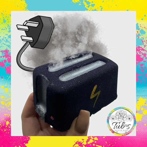 A handmade bath bomb shaped and branded as a 'toaster' — dark-humor self-care gag that's actually a quality fizzer, not just a sticker slapped on a generic bomb.