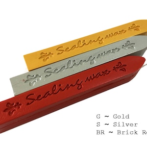 May include: Three rectangular sticks of sealing wax in gold, silver, and brick red. Each stick features the embossed text "Sealing wax" and a fleur-de-lis symbol. Text at the bottom reads: G ~ Gold, S ~ Silver, BR ~ Brick Red.