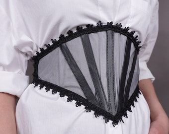 May include: A black mesh corset with a lace trim. The corset has a fan-shaped design with vertical panels.