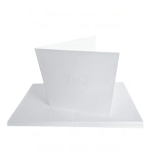 May include: A stack of white blank greeting cards with a folded card on top. The cards are made of textured paper and are set against a white background. The folded card is open, revealing the inside.