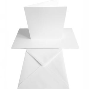 May include: A blank white greeting card, partially opened, with a matching white envelope. The card is rectangular and folded in half, with a clean, minimalist design. The envelope is sealed and positioned below the card.
