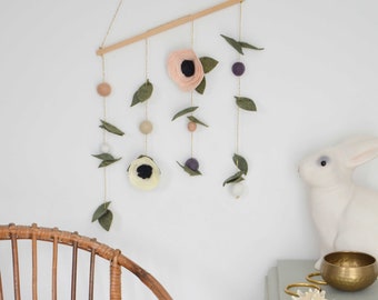Decorative wall mobile with wool flowers and foliage for decorating children's rooms