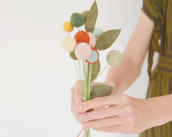 Small bouquet of flowers made from felted wool balls and merino wool leaves