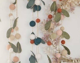 Garland of wool foliage and rust, white and green felted wool balls for decorating the Christmas tree