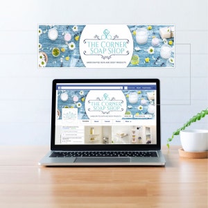 May include: A laptop computer displaying a Facebook page for "The Corner Soap Shop" with a blue and white floral design. The page features a timeline, about, friends, photos, and more tabs. The page header features a blue and white floral design with the text "The Corner Soap Shop" and "Handcrafted Bath and Body Products".