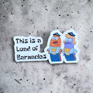 May include: A sticker featuring two cartoon fish characters in police uniforms. The text "This is a Load of Barnacles" is printed on the sticker.