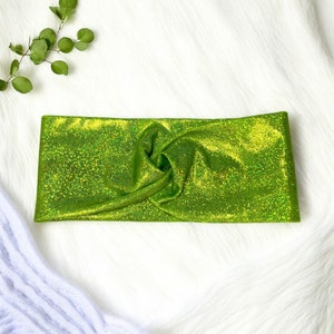 May include: A lime green sparkly headband with a knotted design.