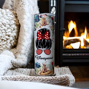 May include: White stainless steel tumbler with a colorful design featuring Disney characters and the text "#DisneyAdult".