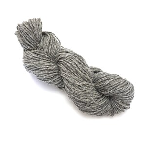 May include: A skein of gray yarn, twisted and ready for knitting or crocheting.