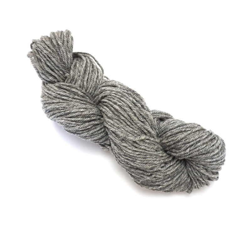 May include: A skein of gray yarn, twisted and ready for knitting or crocheting.