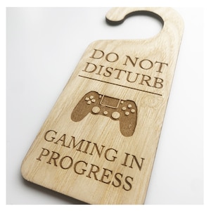 May include: Wooden door hanger with a gamer controller graphic and the text "Do Not Disturb Gaming In Progress".