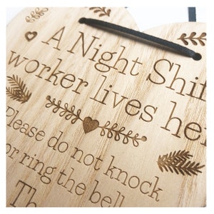 May include: A wooden heart-shaped sign with the text "A Night Shift worker lives here. Please do not knock or ring the bell. Th..."