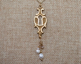 Bright gold ornamental brass keyhole long necklace with pearl and crystal bead droplet dangles