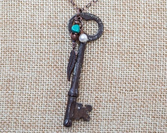Antique bronze-coppery skeleton key long necklace with copper heart and pearl and turquoise beaded dangles and copper feather dangle