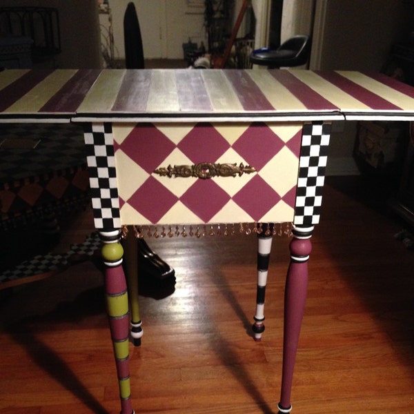 Whimsically inspired , folding vintage side table . Harliquin themed design, stripes whimsical crystal door knobs ,vintage hardware .