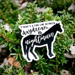 May include: Black and white sticker with a horse silhouette and the text "There's a fine line between daydream & nightmare".