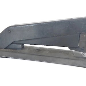 May include: A black metal stapler with a long, rectangular base and a lever on the top. The stapler is designed to hold standard-sized staples.