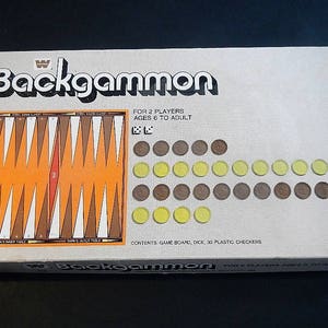 May include: A white box with the words "Backgammon" in black and brown letters. The box shows a game board with brown and white triangles, a red center, and a set of 30 plastic checkers.